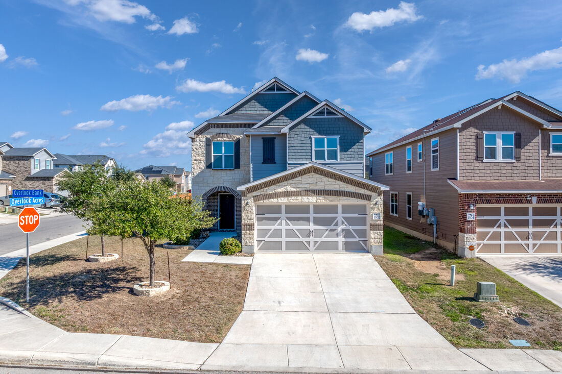 Two-story stone and blue-siding home in a San Antonio neighborhood