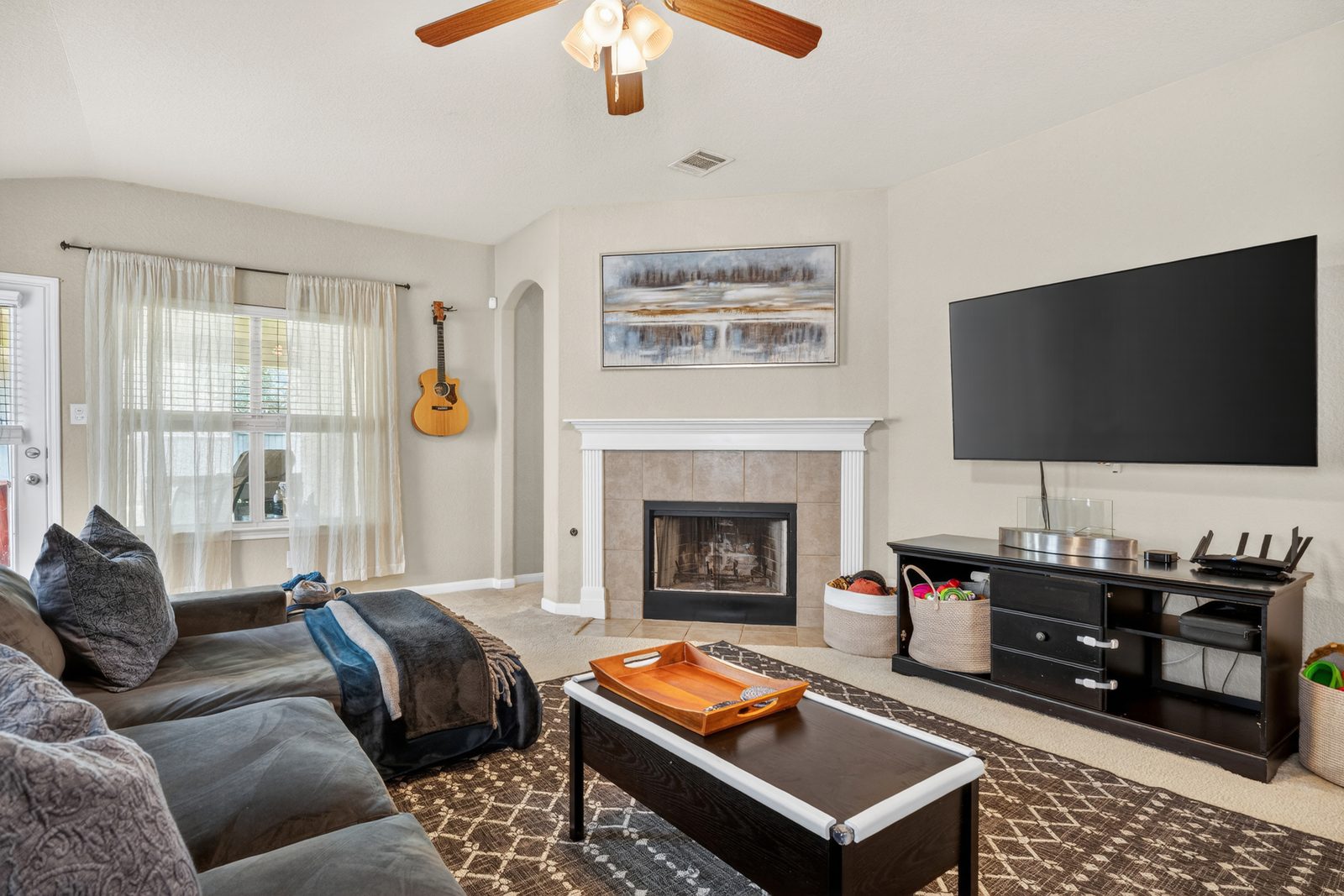Bright living room with fireplace in a managed San Antonio rental